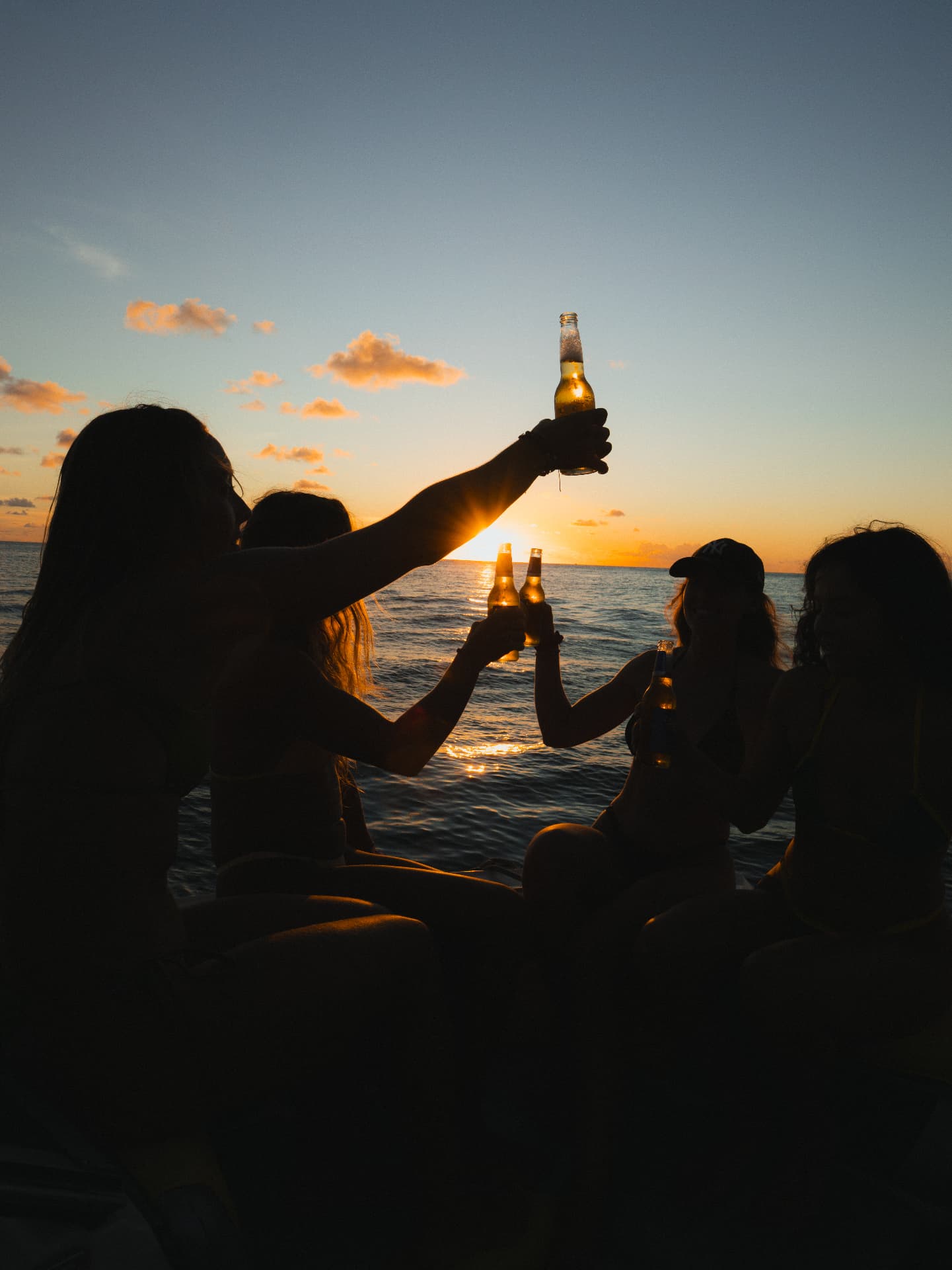 Friends raising drinks together at sunset in Saint-Barthélemy